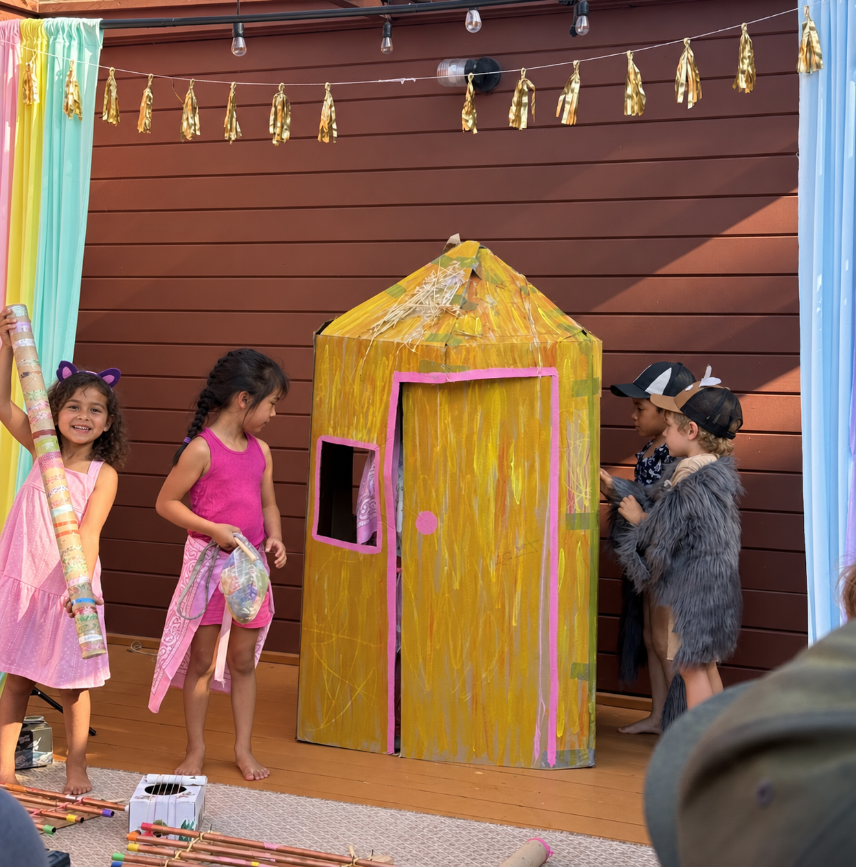 Performing The Three Little Pigs with the handmade house.