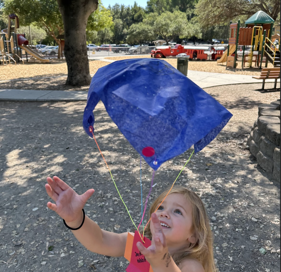 Testing a handmade parachute from the playground.