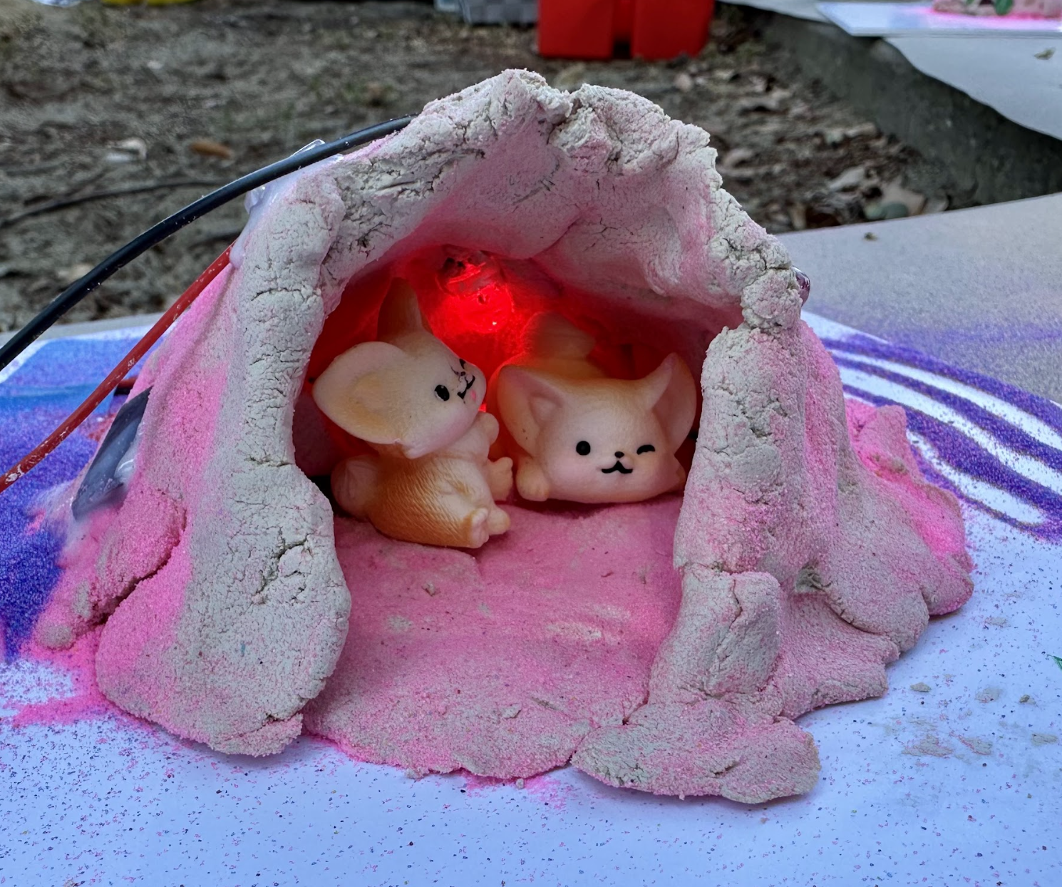 A finished clay Friendship Fort with its fox residents.