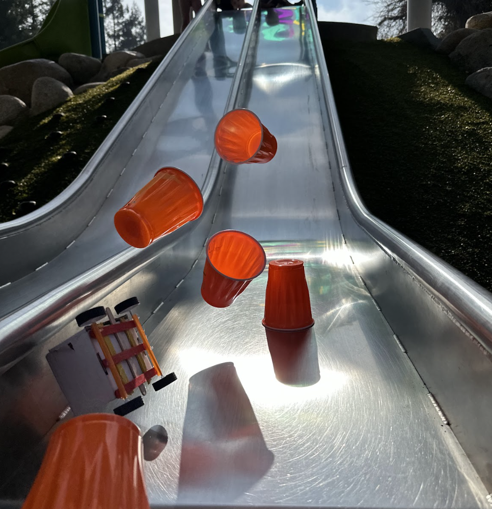A wheeled sleigh being tested against the obstacles on the slide.