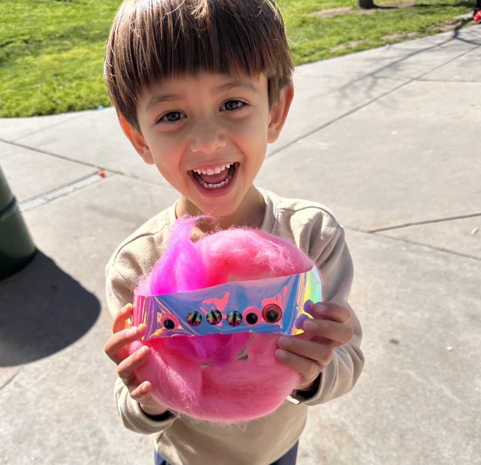 A child sharing an original critter design.